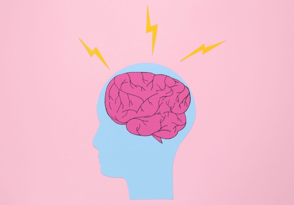 Paper cut human head with brain and arrows on pink background. Headache, brainstorming or flow of ideas concept